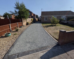 After - Charcoal Block Edging & 3 New Manholes Installed, Finished With Grey Tar And Granite